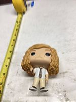Figure beside tape measure showing roughly 4-inch height