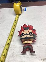 Front view of loose Kirishima Funko Pop with tape measure showing ~4 in height