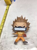 Front view of Funko Pop showing face mask, hair, outfit, measuring tape for scale