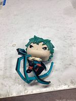 Front view of Funko Pop Izuku Midoriya showing broken teal effect