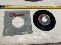 Record and sleeve with measuring tape for scale