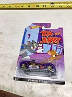 Front of sealed Hot Wheels Power Pipes Tom and Jerry car showing graphics and condition
