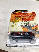 Front of carded Hot Wheels Ryura LX showing car and Tom & Jerry artwork