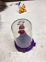 Spider-Man figure inside clear dome on purple base
