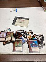Pile of trading cards with Marvel VS System Quick Start Rules booklet
