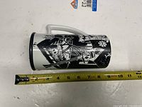 Mug side showing Jack, Sally and Zero illustration with tape measure indicating height