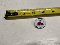 Pin next to tape measure showing size