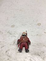 Front view of red/brown sci-fi action figure with helmet and accessory