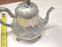Full view of teapot with measuring tape showing height