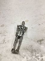 front view of silver/gray droid action figure with harness strap