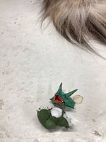 Broken dragon figure head and torso on surface