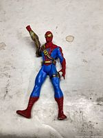 Front view of Spider-Man figure showing harness, gauntlet and paint wear