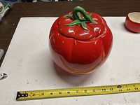 closed tomato jar beside tape measure