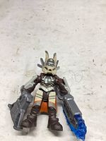 front view of micro action figure holding gray rifle and blue-accented blaster