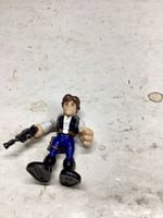 Front view of action figure holding blaster