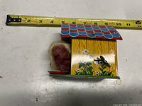 Side view with lithographed flower graphics and wind-up key