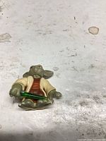 Front view of Yoda figure with lightsaber