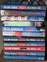 Stack of ten books showing spines and titles