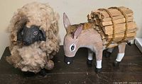 Sheep and donkey figurines side by side