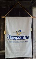 Full view of Hoegaarden banner hanging on wood dowel with cord