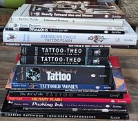 Stacked view of tattoo reference books showing spines and titles