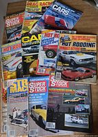 Group shot of all vintage automotive magazines spread on table