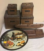 Front view of four wood canisters, dresser valet and metal tray