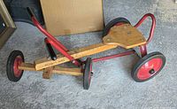 Side view of Radio Flyer row-cart showing frame, handle, wheels