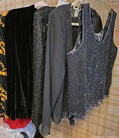 Group shot of four garments hanging