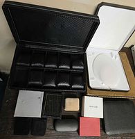 Open 10-slot watch case, white clamshell case, assorted small boxes and eyeglass case