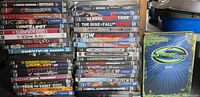Two stacks of WWE DVDs plus separate SummerSlam 2008 case