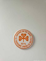 Front of round pinback showing design and text