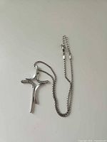 Full view of necklace with chain and cross pendant