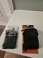 Both camera pouches in packaging on table