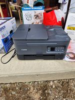 Front view of Canon TR7020a printer with power cord