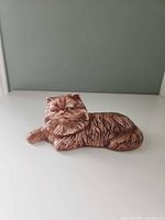 Full view of reclining ceramic cat figurine