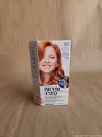 Front of sealed Clairol Nice 'n Easy 8R hair dye box