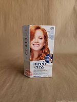 Front view of sealed Clairol Nice 'n Easy 8R hair dye box