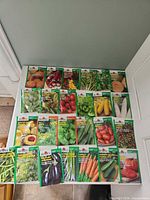 Overview of all 25 Burpee seed packets laid out on tabletop