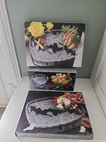 Front view of three boxed glassware sets stacked