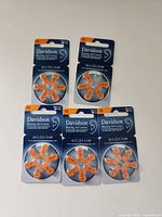 Five packs of Davidson size 13 hearing aid batteries arranged on table