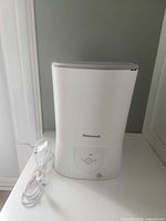 Front view of Honeywell humidifier with coiled power cord