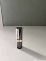 Full tube upright showing barcode and Revlon band