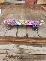 Top view of colorful skateboard on wooden deck