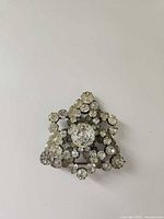Front view of triangular rhinestone brooch