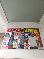 Front view of all three UFC magazines laid out side by side
