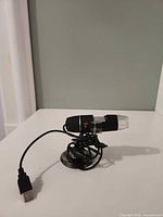 Side view of microscope on stand showing body and cable