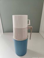 Fully assembled thermos showing blue body and white cup lid