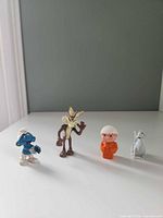 Front view of all four figurines standing side by side