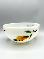 Side view showing fruit motif on white milk glass bowl